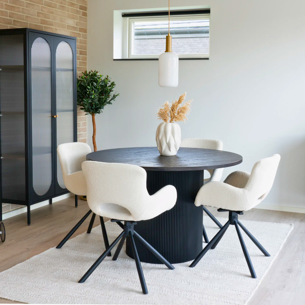 Set van Amorim eetkamerstoelen in off-white bouclé stof met zwarte metalen draaivoet, rond zwarte eettafel in een Scandinavisch interieur van House Nordic.