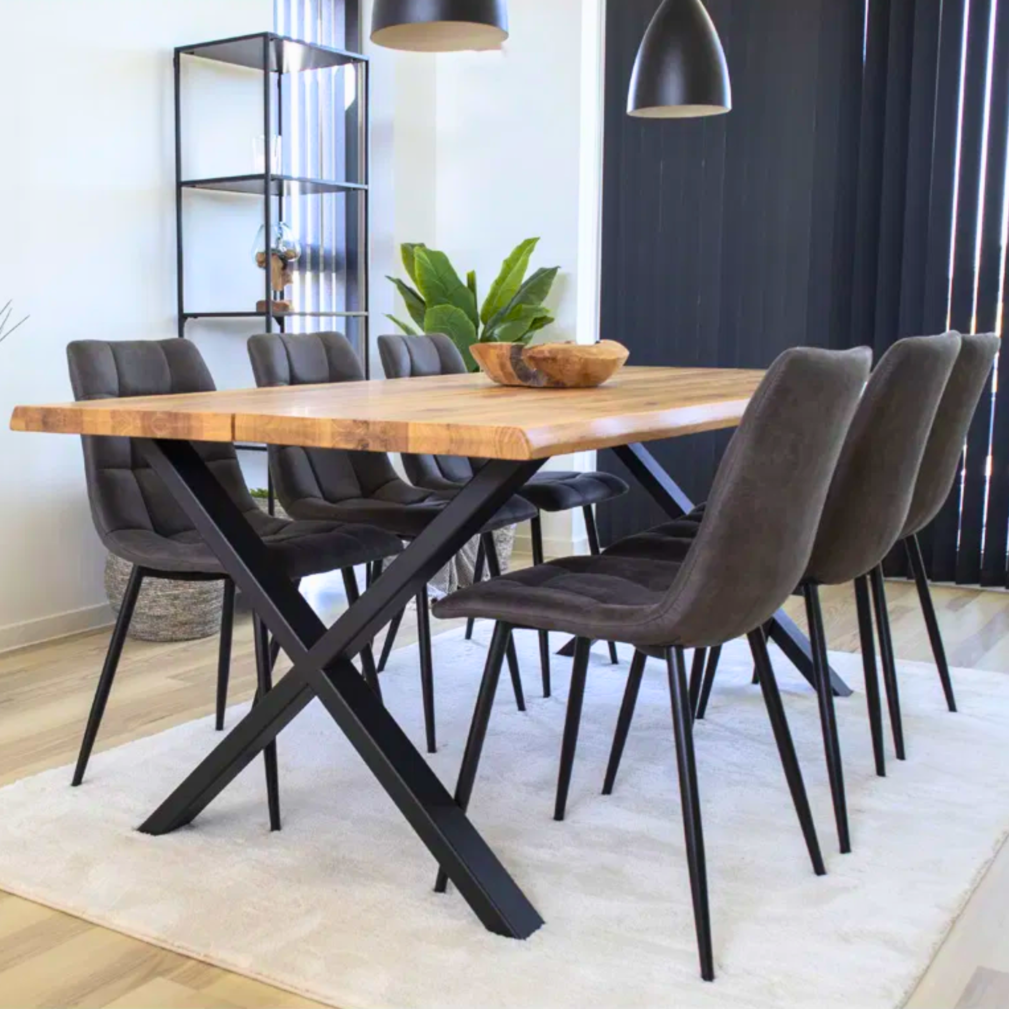 House Nordic Middelfart eetkamerstoelen in donkergrijs microvezel met zwarte poten rond houten eettafel in modern interieur met zwarte accenten.